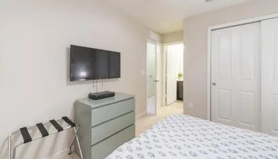 a bedroom with a bed and a tv on a wall at Townhome at Compass Bay Community in Kissimmee