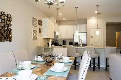 a dining room and kitchen with a table and chairs at Townhome at Compass Bay Community in Kissimmee