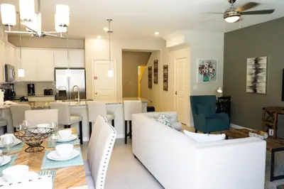 a dining room and living room with a table and chairs at Townhome at Compass Bay Community in Kissimmee