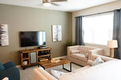 a living room with a couch and a television at Townhome at Compass Bay Community in Kissimmee