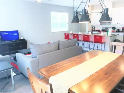 a living room with a couch and a table at Townhome at Compass Bay Community in Kissimmee