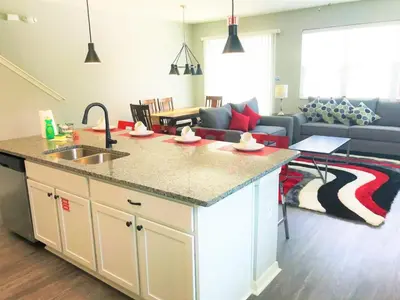 a kitchen and living room with a sink and a counter at Townhome at Compass Bay Community in Kissimmee