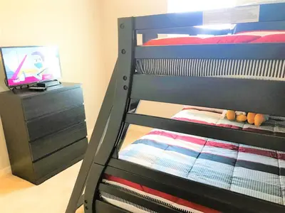 a bunk bed with a tv in a bedroom at Townhome at Compass Bay Community in Kissimmee