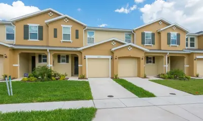 a large house with a driveway at Townhome at Compass Bay Community in Kissimmee