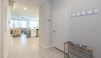a room with a white door and a living room at Townhome at Compass Bay Community in Kissimmee