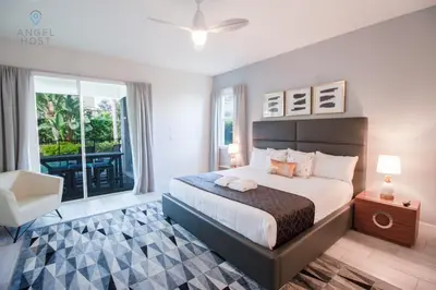 a bedroom with a large bed and a balcony at Private Pool and Spa Home at Encore Resort at Reunion in Orlando