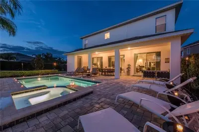 a house with a swimming pool and some chairs at Private Pool and Spa Home at Encore Resort at Reunion in Orlando