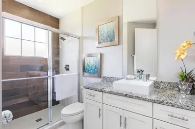 a bathroom with a toilet and a sink and a shower at GORGEOUS 5 Suites Villa at Summerville Resort in Orlando