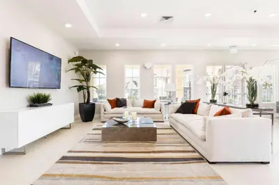 a living room with two white couches and a tv at GORGEOUS 5 Suites Villa at Summerville Resort in Orlando