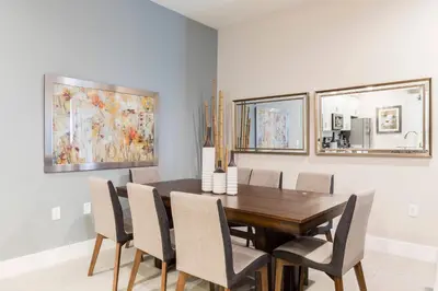 a dining room with a wooden table and chairs at GORGEOUS 5 Suites Villa at Summerville Resort in Orlando