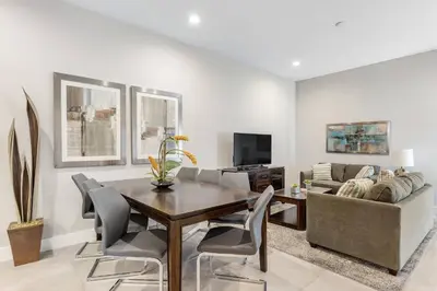 a dining room with a table and a couch at Fantastic 4 beds Villa 5 min to Disney in Orlando