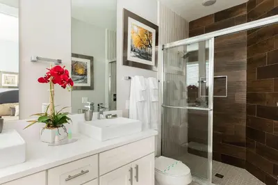 a bathroom with a sink and a glass shower at Fantastic 4 beds Villa 5 min to Disney in Orlando