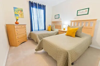 a bedroom with two beds and a dresser at 8536 Crystal Cove in Kissimmee