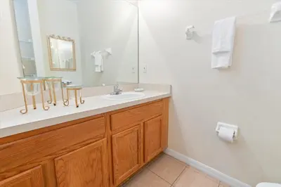 a bathroom with a sink and a mirror at 8536 Crystal Cove in Kissimmee