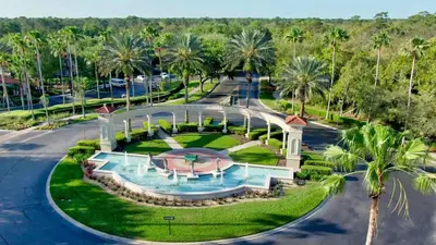 an aerial view of a resort with a swimming pool and palm trees at 8536 Crystal Cove in Kissimmee
