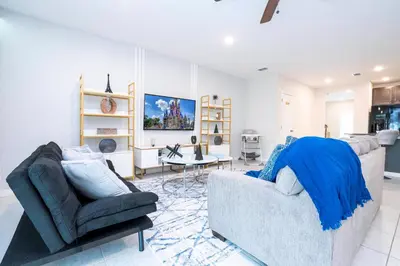 a living room with a couch and a chair at Amazing 3BedroomsNear to DisneyThemed rooms in Kissimmee