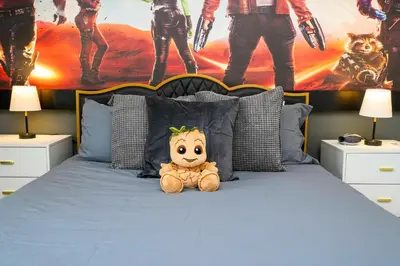 a teddy bear sitting on top of a bed at Amazing 3BedroomsNear to DisneyThemed rooms in Kissimmee