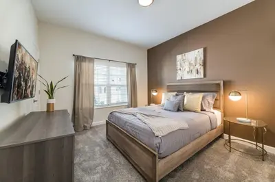 a bedroom with a large bed and a window at Beautiful house great location private pool in Kissimmee