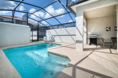 an indoor swimming pool with a glass ceiling at Beautiful house great location private pool in Kissimmee