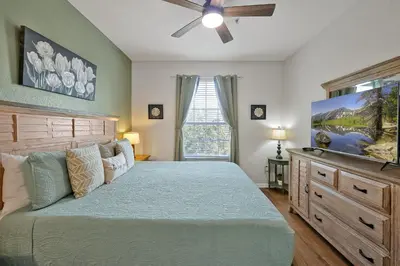 a bedroom with a bed and a ceiling fan at Sunny Condo Retreat at Windsor Hills in Orlando