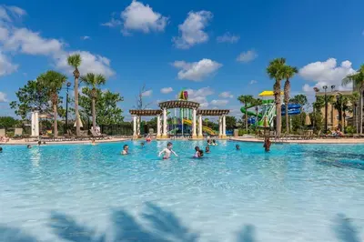 a group of people in a swimming pool at a theme park at Best Family Friendly Spot at Windsor Hills in Orlando