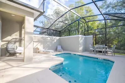 a swimming pool in a house with a glass roof at NEW to Market 5 Bed - Storey Lake Retreat in Kissimmee