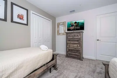 a bedroom with a bed and a tv on a wall at NEW to Market 5 Bed - Storey Lake Retreat in Kissimmee