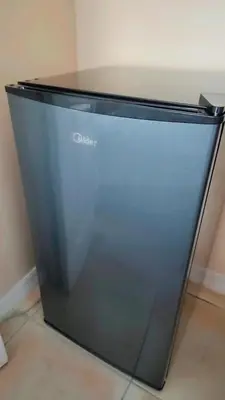 a close up of a black refrigerator in a room at Pily's Vintage Stay Room Full Bed in Orlando