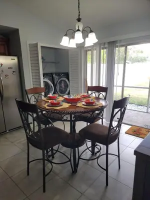 a dining room table with chairs and a kitchen with a tableablish at Pily's Vintage Stay Room Full Bed in Orlando