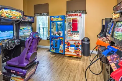 a room with arcade games and video games at Townhome at Emerald Island Resort in Kissimmee
