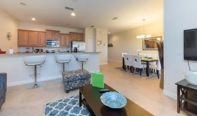a living room with a kitchen and a dining room at Private Pool Townhome at Paradise Palms Resort in Kissimmee