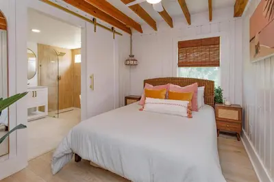 a bedroom with a bed with orange and white pillows at Hope Home in Clermont