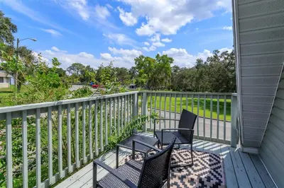 a porch with two chairs and a fence at Hope Home in Clermont