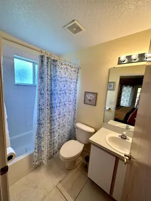 a bathroom with a toilet and a sink at Grand Holiday 3BR Condo Resort near Disney Parks in Kissimmee