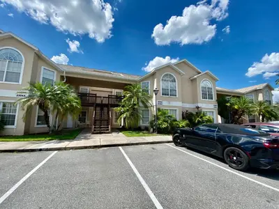 a black car parked in front of a house at Grand Holiday 3BR Condo Resort near Disney Parks in Kissimmee