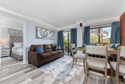 a living room and dining room with a couch and a table at Exclusive Second-Floor Apartment in Orlando