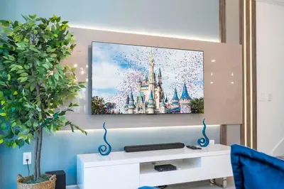 a flat screen tv hanging on a wall at Wonderful 5 Bd w Pool @ Storey Lake Resort 2545 in Kissimmee