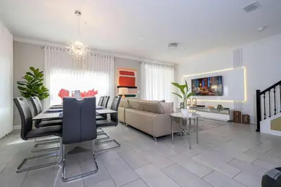 a living room with a couch and a dining room at Free Waterpark 5Bd Close to Disney Private Pool 2497 in Kissimmee