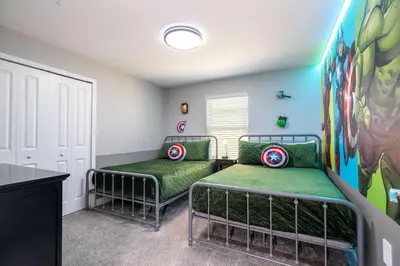a bedroom with two beds and a painting on the wall at Free Waterpark 5Bd Close to Disney Private Pool 2497 in Kissimmee