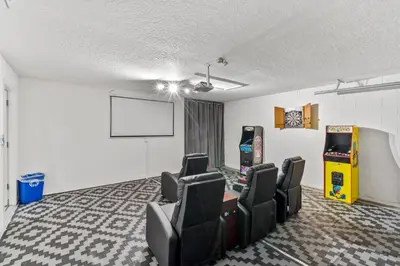 a room with chairs and a video game at 4676 Cumbrian Lakes in Kissimmee