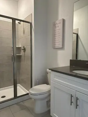 a bathroom with a toilet and a shower and a sink at COLORING in Kissimmee