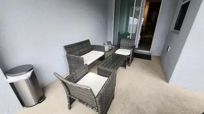 a group of wicker chairs and a trash can at COLORING in Kissimmee
