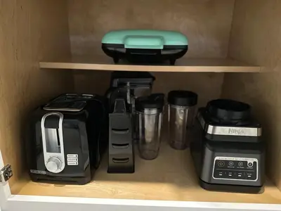 a cupboard with various kitchen items on a shelf at COLORING in Kissimmee