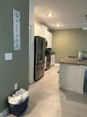 a kitchen with a refrigerator and a counter top at COLORING in Kissimmee