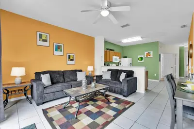 a living room with two couches and a table at 7644 Sir Kaufmann in Kissimmee