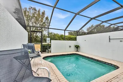 a swimming pool in a house with a glass ceiling at 7644 Sir Kaufmann in Kissimmee