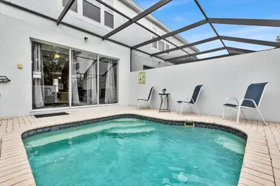 a swimming pool in a house with a glass ceiling at 7644 Sir Kaufmann in Kissimmee
