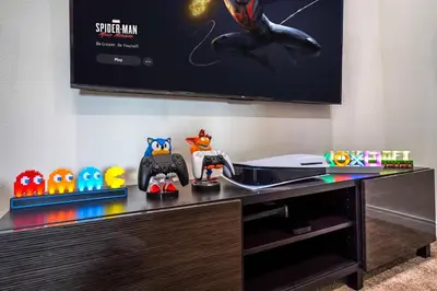 a desk with a tv and some toys on it at Magical Themed Home Near Disney in Orlando