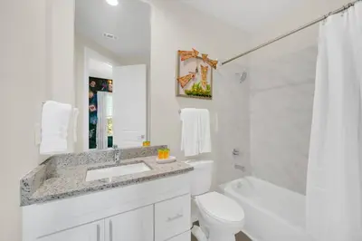 a white bathroom with a sink and a toilet at Magical Themed Home Near Disney in Orlando