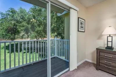 a room with a balcony with a sliding glass door at 2764 Sun Key in Kissimmee